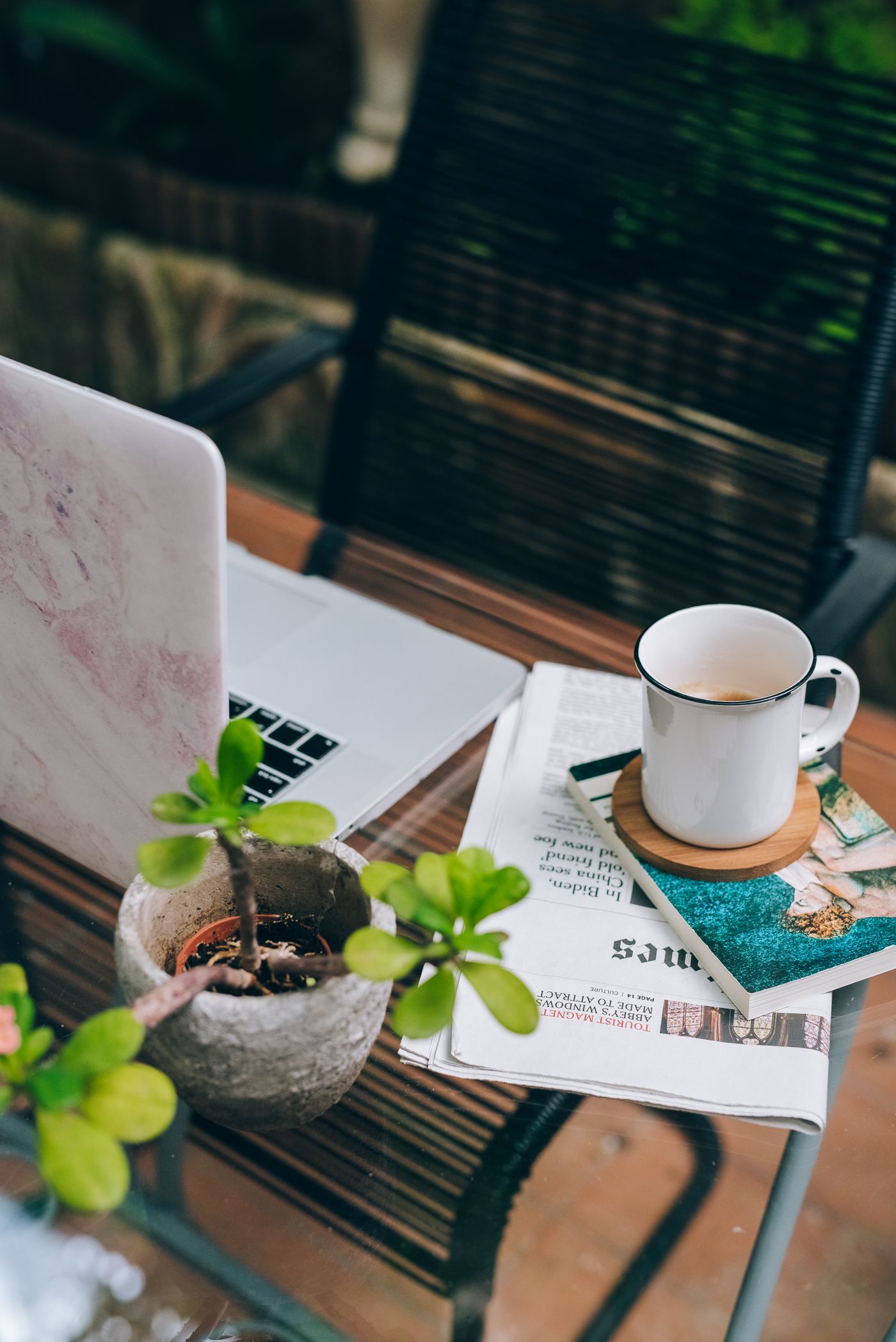 Coffee and a laptop on a garden table, a room designed to be lived in