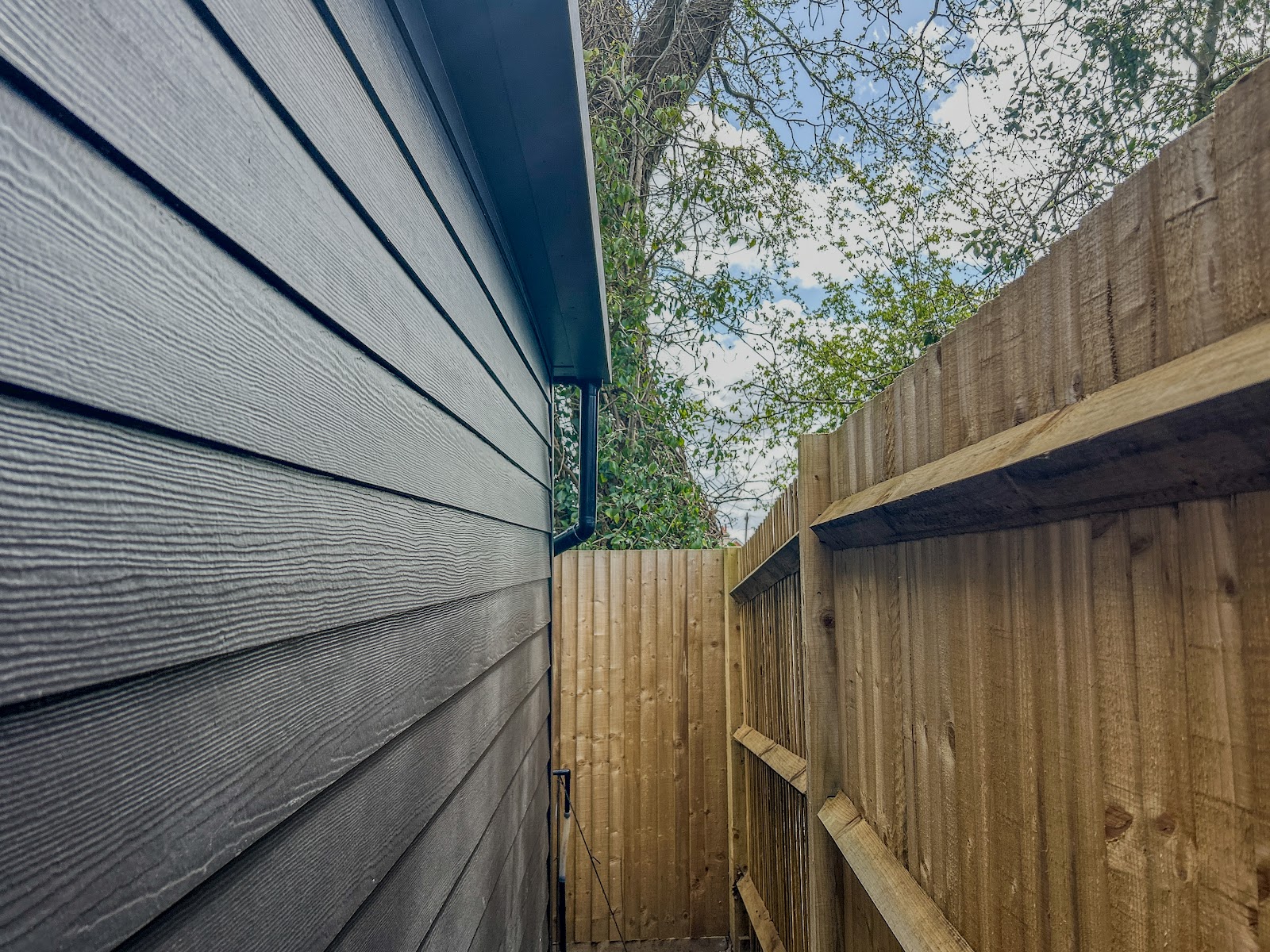 The run down the side of a finished room, sitting neatly between building and boundary fence.